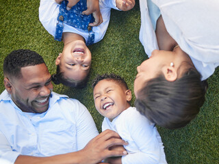 Poster - Parents, children and lying on grass with laughing, tickling and game with connection on vacation. People, mother and father with kids on lawn at park, garden and above with playful family in Brazil