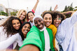 © Xavier Lorenzo - Happy young group of diverse women taking selfie portrait at city street. Female community and friendship concept.