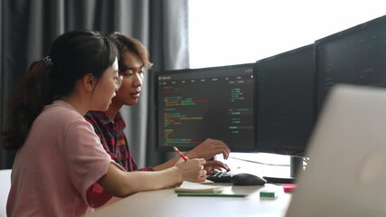 Back end software developer engineer for computer programming working together on debugging writing computing code, solving complex algorithms display on monitor in office. Burgeoning