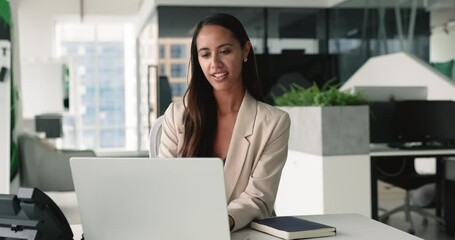 Attractive young businesswoman working sitting in modern co-working office, ponder on task, review project, develop strategy, engaged in brainstorm, thinking, looks satisfied with workflow use laptop