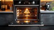 © Helois - Modern black oven with the door open and the interior light on.