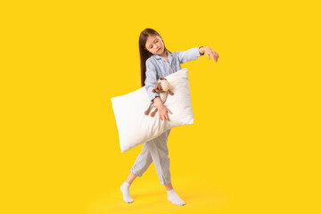 Wall Mural - Little sleepwalker with pillow on yellow background