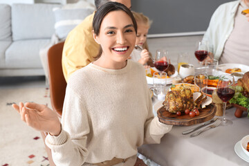 Poster - Young woman having family dinner at festive table on Thanksgiving Day