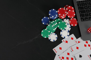 Canvas Print - Online poker. Playing cards, chips, dice and laptop on black table, top view. Space for text