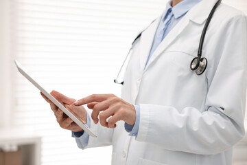 Wall Mural - Doctor using tablet in hospital, closeup view