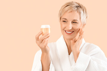 Sticker - Mature woman with jar of cream on beige background, closeup