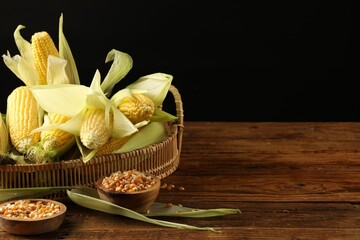 Wall Mural - Many fresh ripe corncobs with green husks and kernels on wooden table. Space for text