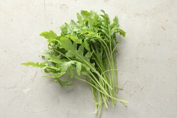 Poster - Many fresh arugula leaves on grey textured table, top view