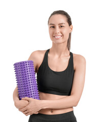 Wall Mural - Sporty young woman with foam roller on white background