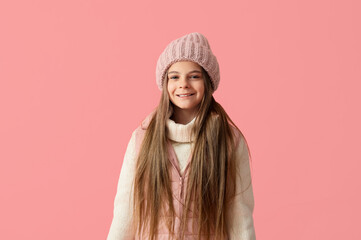 Canvas Print - Cute little stylish happy girl in winter clothes on pink background