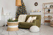 © Pixel-Shot - Interior of living room with sofa, Christmas tree and burning candles