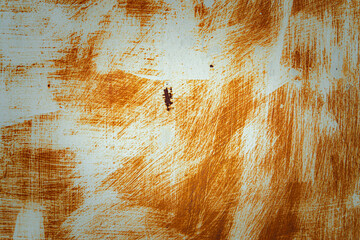 A wall with a brown and white paint splatter. The wall has a rough texture and he is old