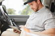 © Flashizzle/peopleimages.com - Reading, tablet or delivery man in van to search for directions to location or shipping address. Online order, logistics or courier worker in car vehicle for ecommerce package, supply or checklist