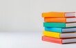 © srenhouse - Colorful books stack on white background with copy space