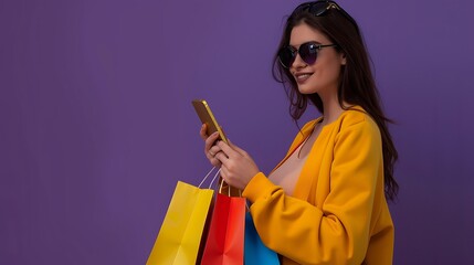 Wall Mural - Young woman in sunglasses, holding shopping bags, using mobile phone, purple background, copy space for banner.