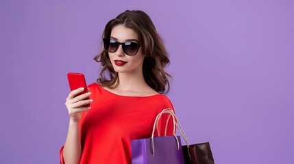 Wall Mural - Young woman in sunglasses and shopping bags, using mobile phone for orders, purple background, copy space for advertising.