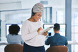 © peopleimages.com - Office, black woman and happy with tablet at call center for research on customer service and telemarketing. Female person, team leader and smile or proud with headset for training and internship