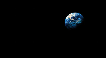 Wall Mural - earth illuminated in the infrared spectrum against a vast black space backdrop highlighting its beau