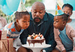 © Nina2024/peopleimages.com - Man, blowing candles and birthday cake with children for celebration, gathering and event in home for happiness. African father, kids and excited at party with support, love and together for surprise