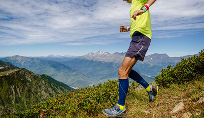 Wall Mural - runner in compression socks running on steep slope mountain marathon