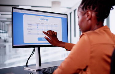 Wall Mural - African Woman Filling Online Survey Form On Laptop Computer