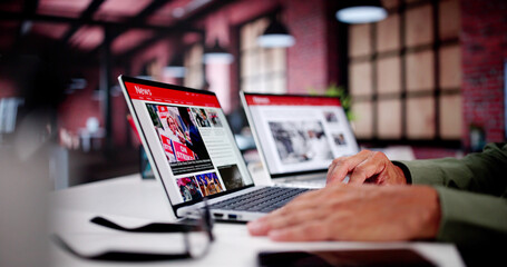 watching online news article on mobile phone and laptop