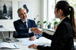© MOTOKO Stock - Hiring Manager Shakes Hands with Job Candidate: Professional Office Setting for Corporate Recruitment