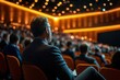 © Karn AS Images - Rear view of diverse business audience listening attentively, conference speaker in focus, modern conference hall, dynamic lighting, professional atmosphere