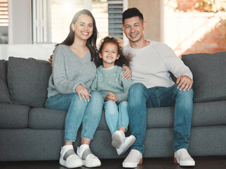 Poster - Happy, portrait and child with parents on sofa in home for bonding, security and family time. Smile, relax and girl kid with mother and father in living room for care, love or connection at house.