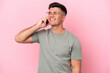 © luismolinero - Young caucasian handsome man isolated on pink background keeping a conversation with the mobile phone