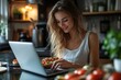 © Lumina Frame - Young woman using laptop while eating bruschetta in the kitchen, Generative AI