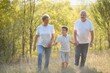 © Serhii - Grandparents and grandson together in autumn park