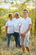 © Serhii - Grandparents and grandson together in autumn park