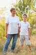 © Serhii - A beautiful grandmother spends time with her grandson in nature at sunset