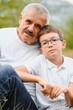 © Serhii - Grandfather and grandson walking at sunset