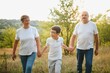 © Serhii - Grandfather grandmother and grandson having fun outdoors in park