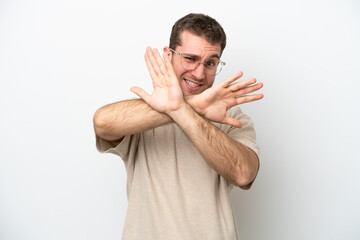 Wall Mural - Young caucasian man isolated on white background nervous stretching hands to the front