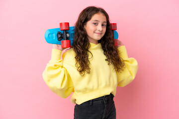 Wall Mural - Little caucasian girl isolated on pink background with a skate with happy expression