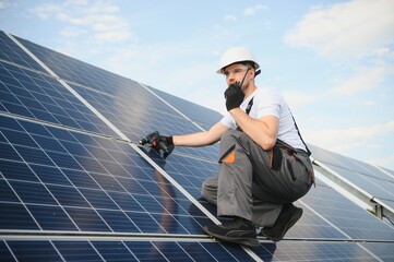 Poster - Worker installing solar panels outdoors