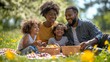 © Oscar - Happy African American family enjoying a picnic outdoors on a sunny day