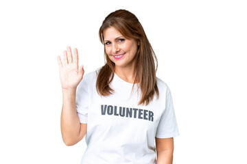 Canvas Print - Middle age volunteer woman over isolated background saluting with hand with happy expression