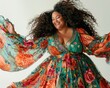 © Boomanoid - Portrait of an attractive, smiling plus size woman with long curly hair dancing and wearing a bright floral dress
