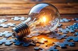 © Danicha - A bright light bulb moment with a puzzle piece fitting perfectly into place, symbolizing a challenging problem