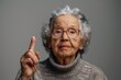 © Boomanoid - Elderly woman with glasses making peace sign