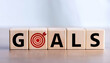 © stockpro - Wooden blocks spelling 'GOALS' with a target symbol, representing ambition, motivation, and achievement in personal or professional life.