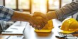 © Boomanoid - Construction workers shake hands in agreement
