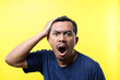 © ArvStd - Close up photo of Shocked asian man against yellow background