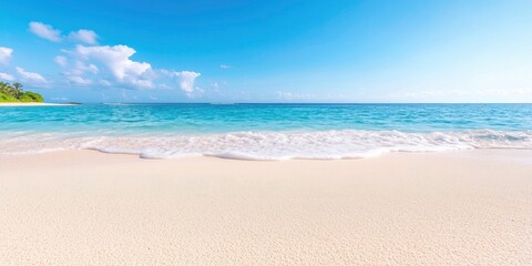 Wall Mural - Gorgeous white sand beach with peaceful,rolling waves of the turquoise ocean on a sunny day with white clouds in the blue sky in the backdrop.