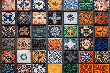 Naklejka na meble Brightly colored tiles with traditional patterns. Arranged neatly on the wall, each tile is painted with a unique design.