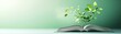 © Rossarin - An open book with a green plant growing from its pages, symbolizing knowledge and growth in a serene setting.